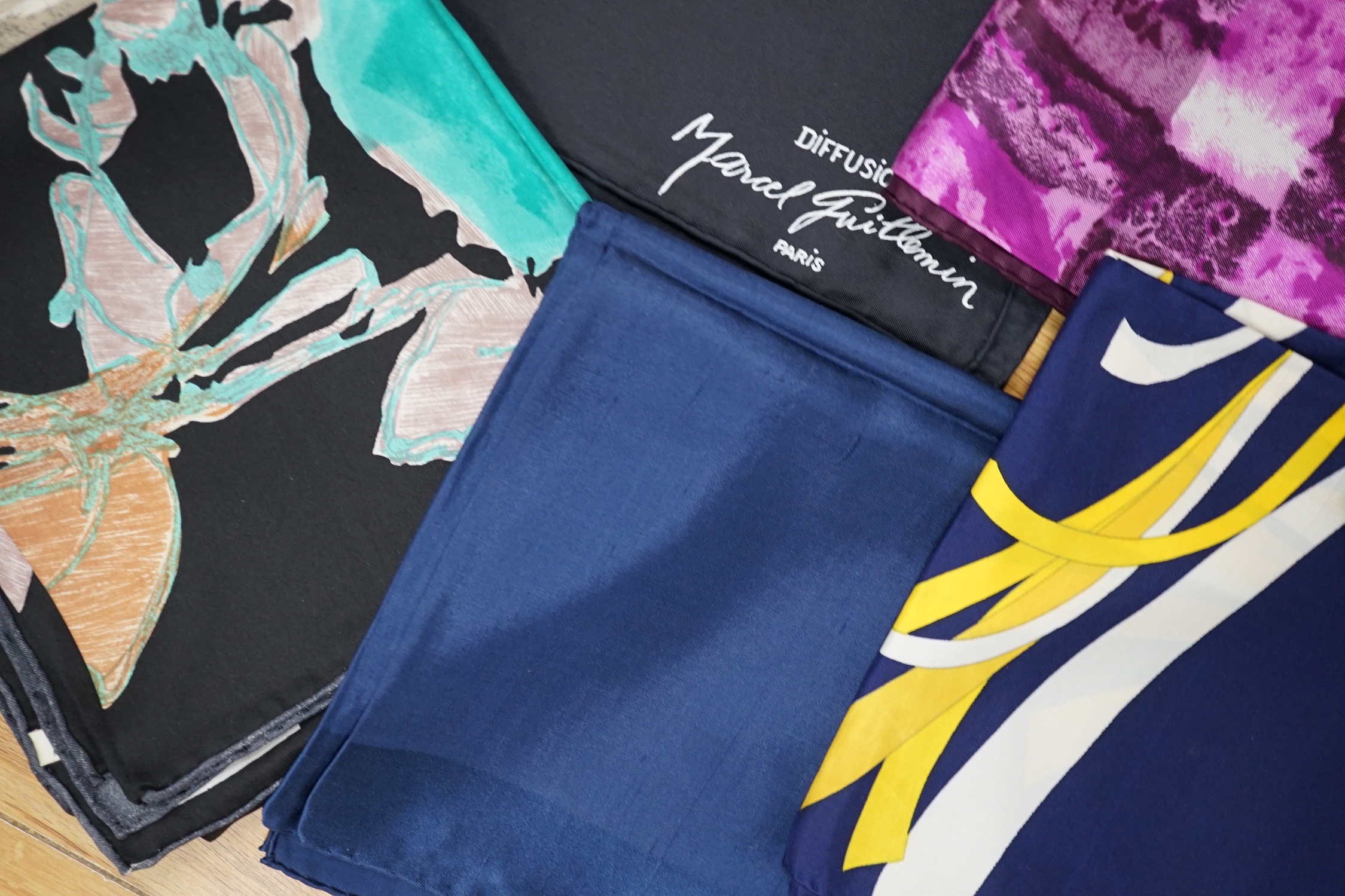 A collection of vintage silk scarves including Lanvin, Yves Saint Laurent, Maggy Rouff and one retailed by Harrods